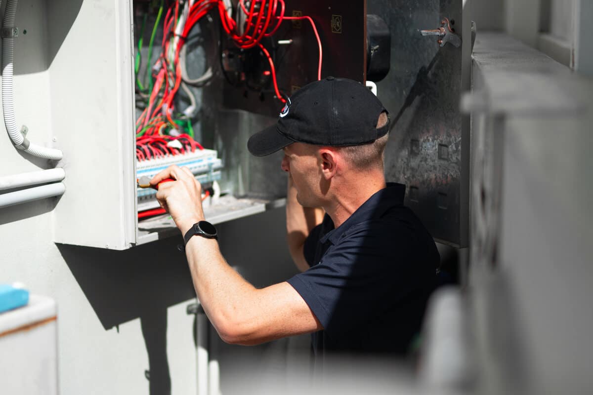 Moral Service electrician working on a switchboard on the Gold Coast