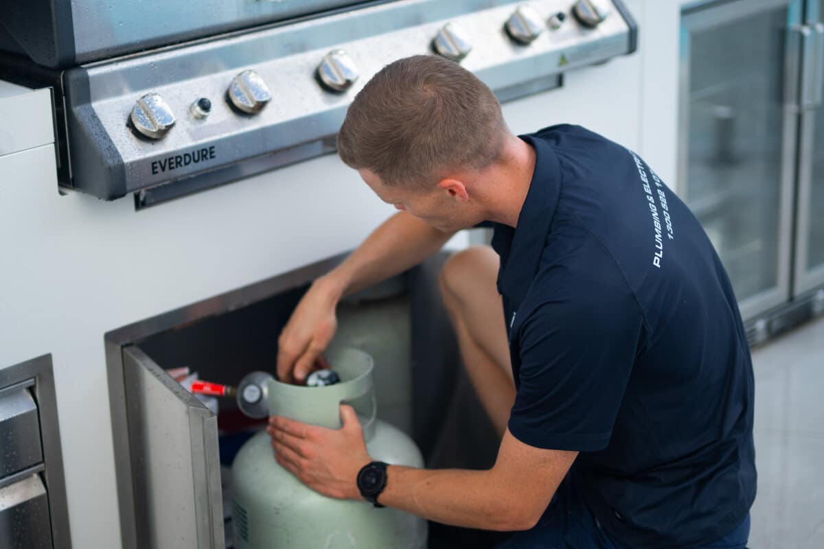 Moral Service plumber connecting a gas bottle at a Gold Coast home