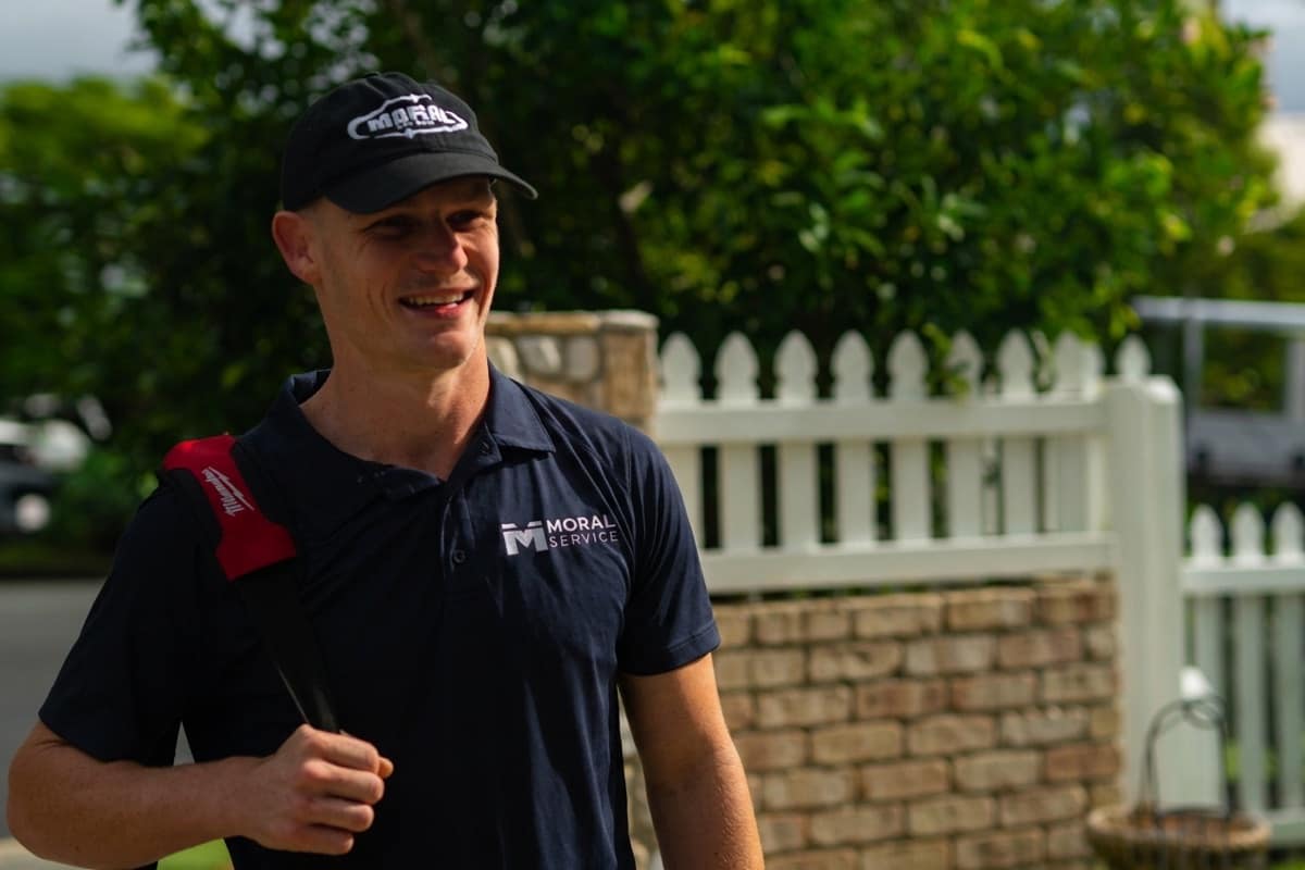 Justin from Moral Service arriving at a Gold Coast job with his tool bag over his shoulder