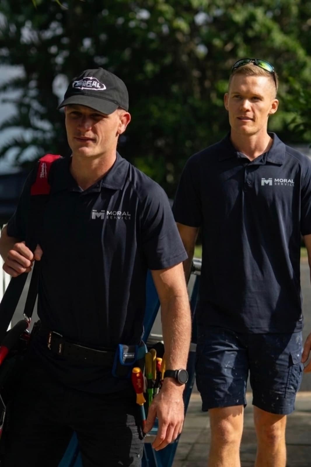 Shaun and Justin walking in to a Gold Coast job together, tool bag and ladder in hand